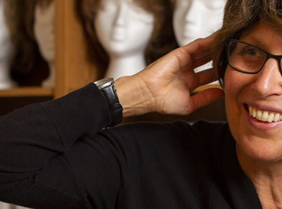 A woman trying on a wig