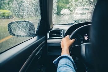 A photo of a person driving a car.