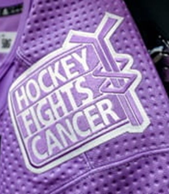 A hockey jersey with a hockey fights cancer patch.