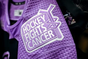 A hockey jersey with a hockey fights cancer patch.