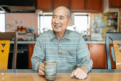 Man sitting at a table holding a mug