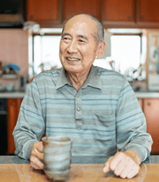 Man sitting at a table holding a mug