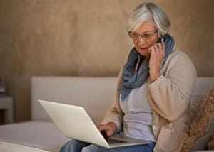 Woman on mobile phone and laptop