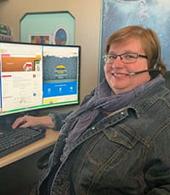 Carrie Van Lingen, Cancer Information Specialist, sitting at a computer.