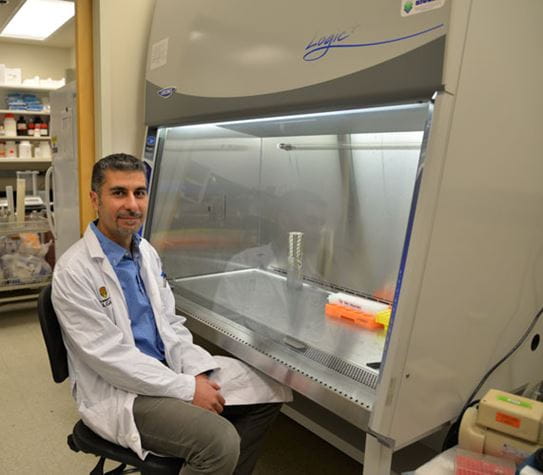 Dr Tarek Bismar sitting in a laboratory