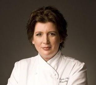 Chef Lynn Crawford poses wearing a chef’s jacket.