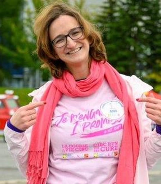 Marie-Noëlle in a pink shirt that says “CIBC Run for the Cure”