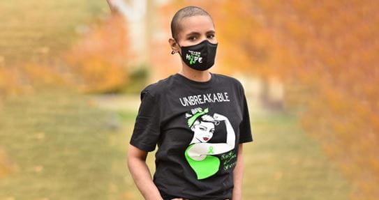 Harjeet Kaur stands outside wearing a cloth mask