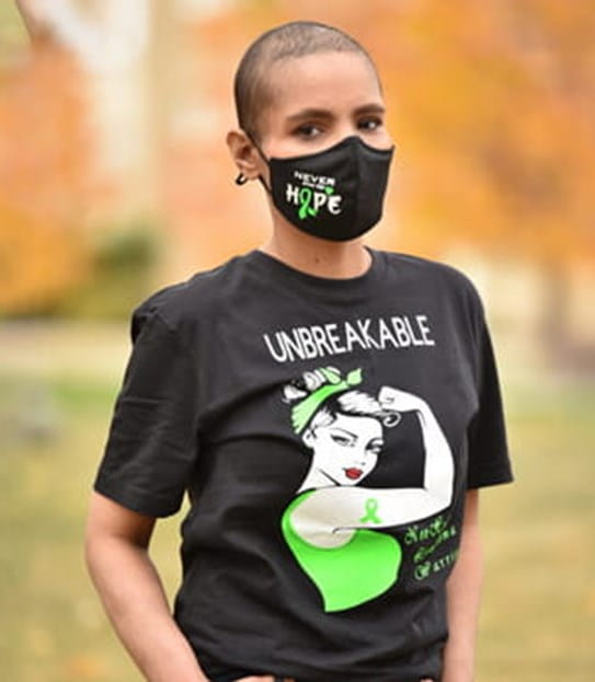 Harjeet Kaur stands outside wearing a cloth mask