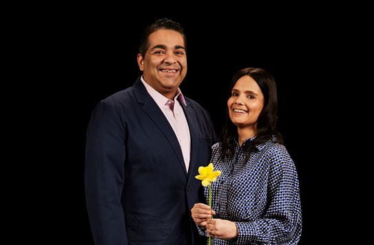 Harjeet standing next to her husband, holding a daffodil