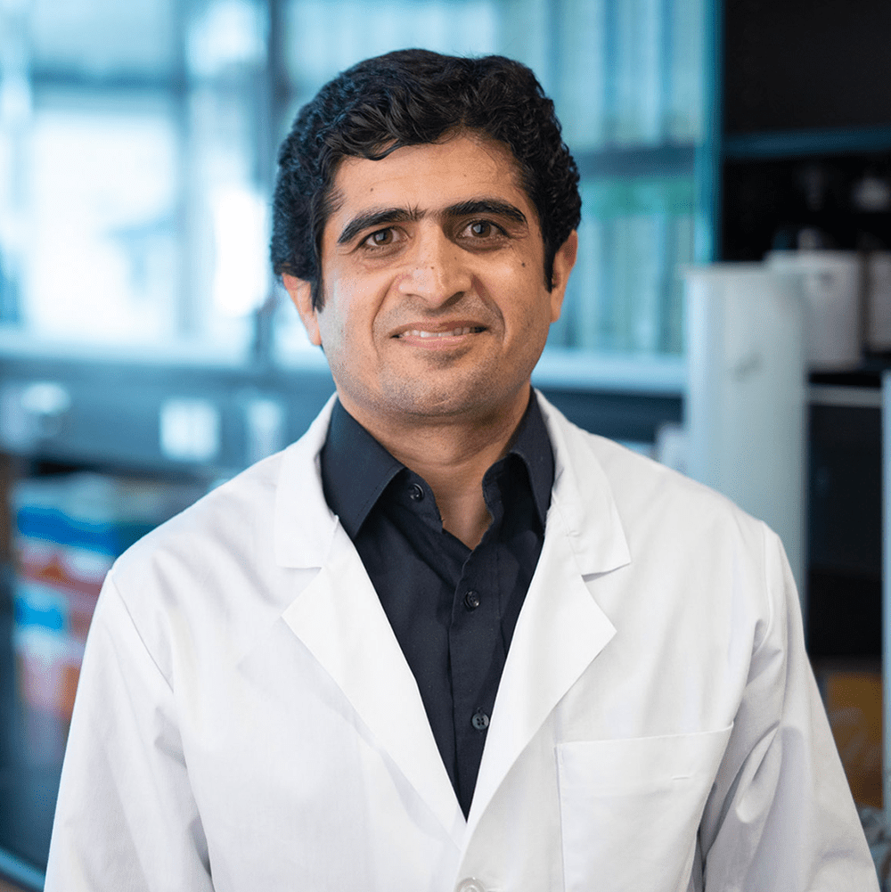 Dr Sharif in his lab in a white coat 