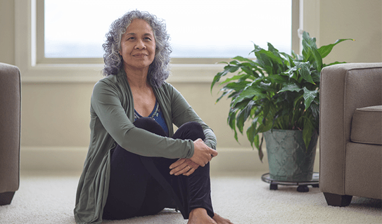 A photo of a woman sitting on the floor 