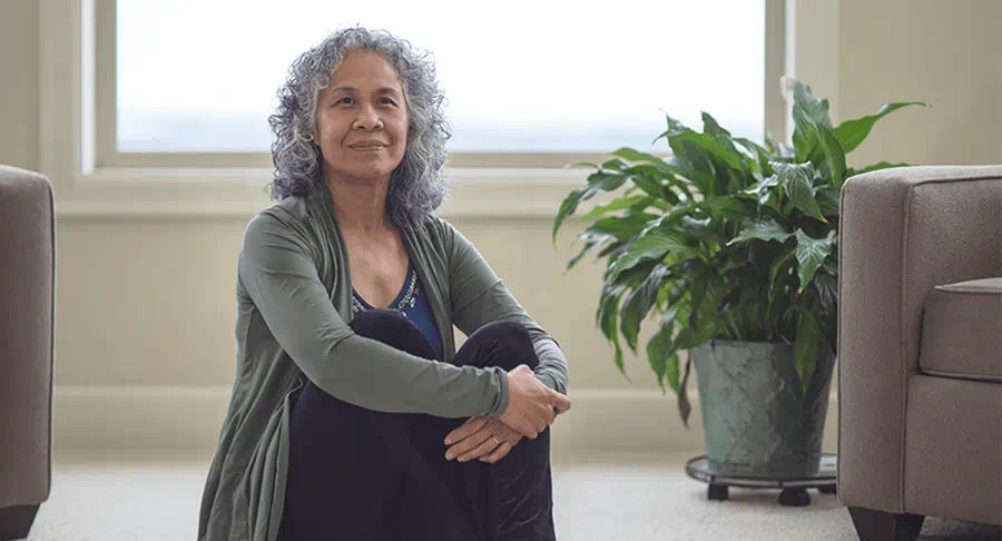 A photo of a woman sitting on the floor
