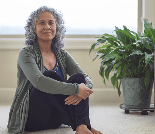 A photo of a woman sitting on the floor