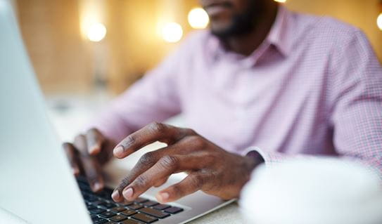 A man on a laptop doing online research