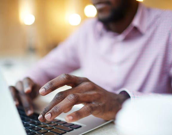 A man on a laptop doing online research