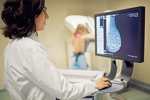 A doctor running a mammogram test.