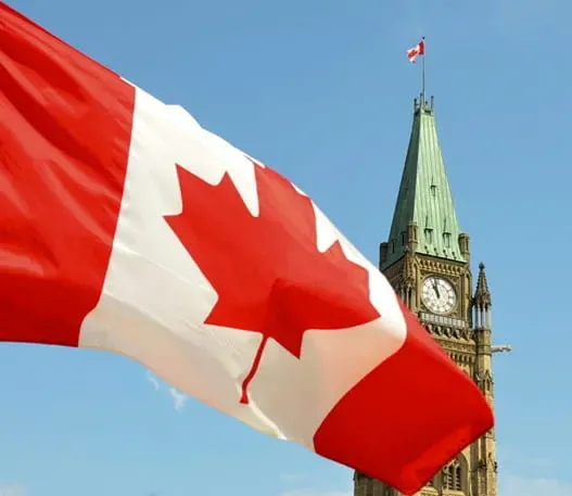 Canadian provincial flags waving against a blue sky
