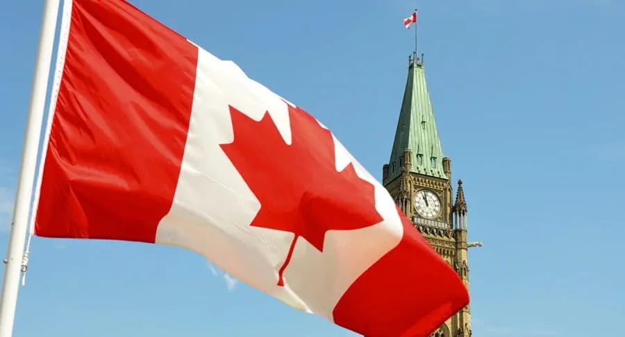 Canadian provincial flags waving against a blue sky