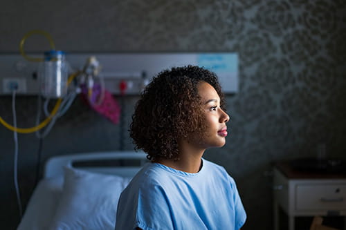 A woman sitting on a hospital bed