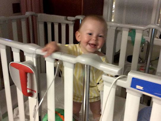 Aeson smiling while standing in his hospital bed