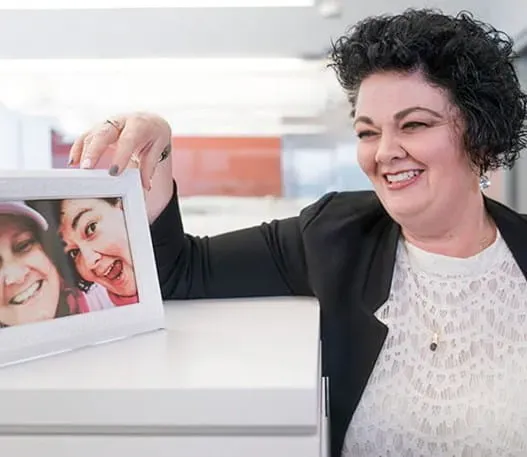 Tammy holding a photo of herself and Niki
