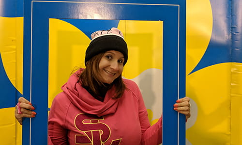 Sarah Midea, Cancer Survivor, holding up a large sized event photo frame
