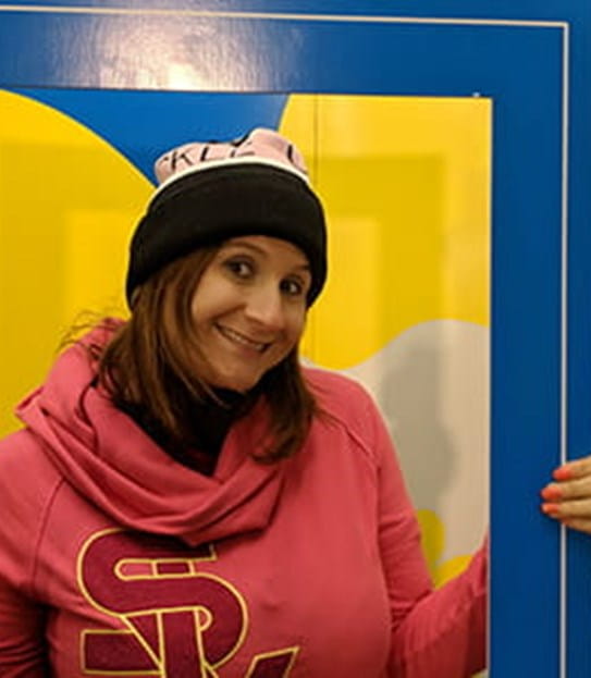 Sarah Midea, Cancer Survivor, holding up a large sized event photo frame