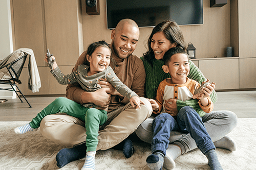 A mother and father laughing with their children.