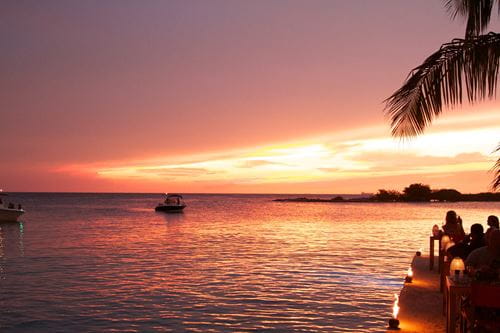 .A restaurant overlooking a beach at dusk.