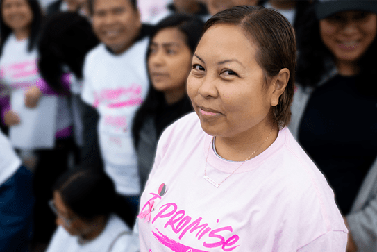 Maja surrounded by a group of people at a past Canadian Cancer Society CIBC Run for the Cure event.