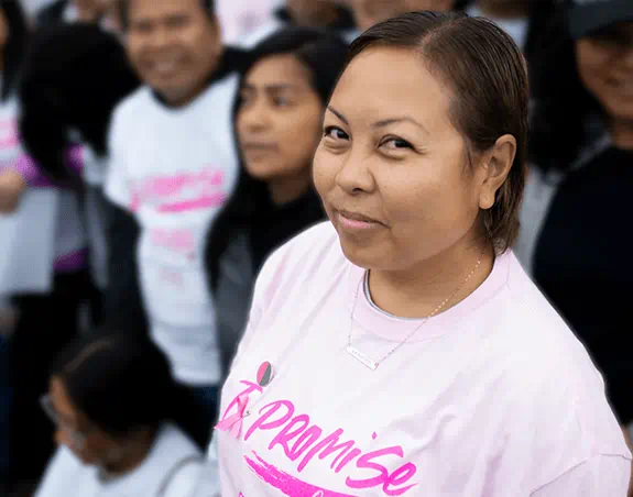 Maja surrounded by a group of people at a past Canadian Cancer Society CIBC Run for the Cure event.