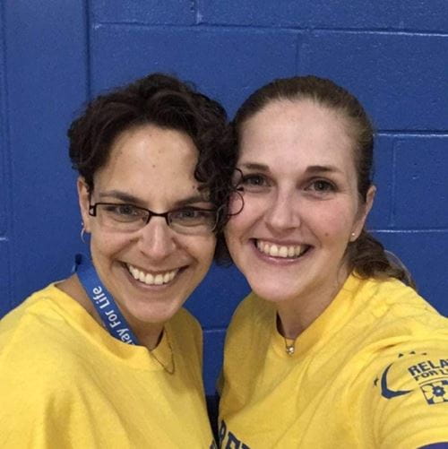 Melanie and a friend wearing their Relay For Life shirts.