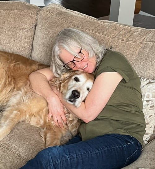 Nancy cuddling with her dog.