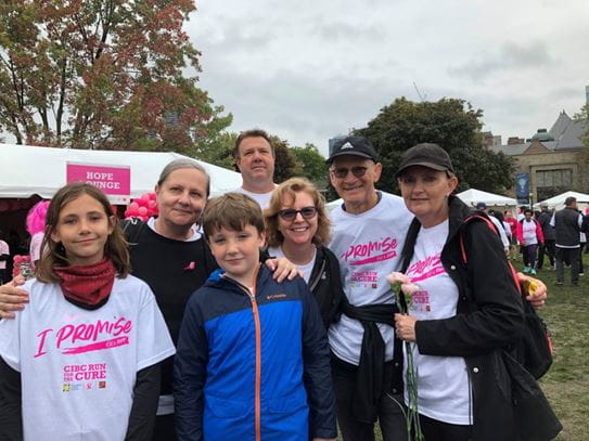 Konstance standing at the far-left holding two roses, with her children, husband and supporters.