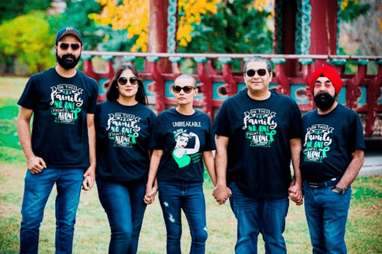 Harjeet and her family wearing cancer fundraising t shirts.