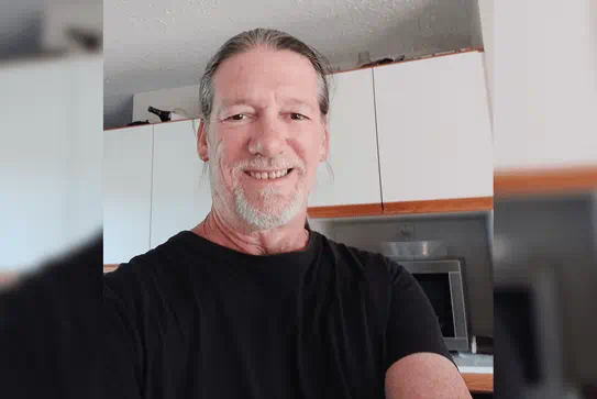 Mark in his kitchen, smiling at the camera.