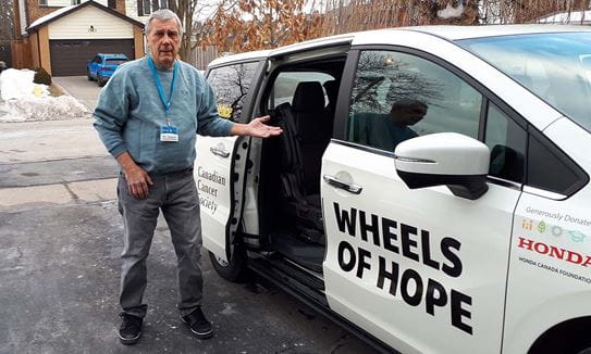 Bob standing beside the Wheels of Hope car in his driveway.