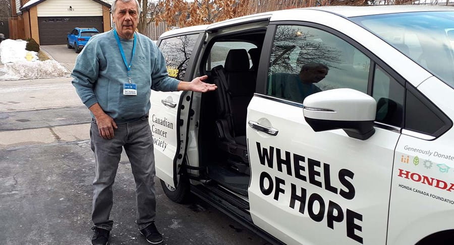 Bob standing beside the Wheels of Hope car in his driveway.
