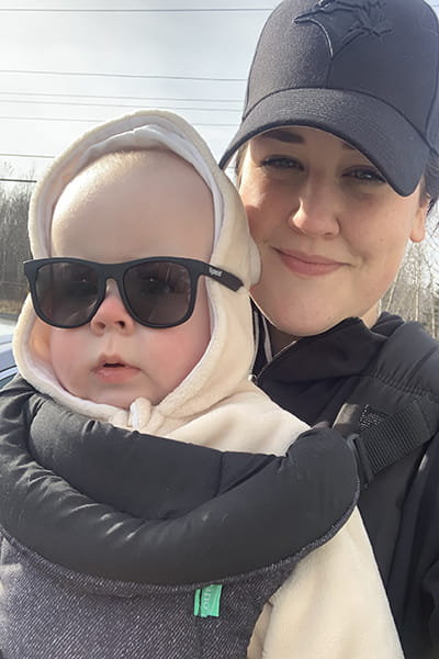 Danielle with her 5-month-old boy, outside on a Winter day.