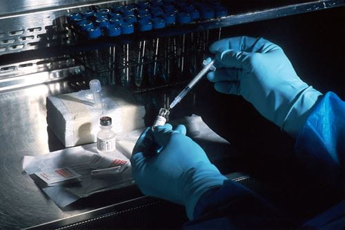 Researcher's hands in a cancer lab.