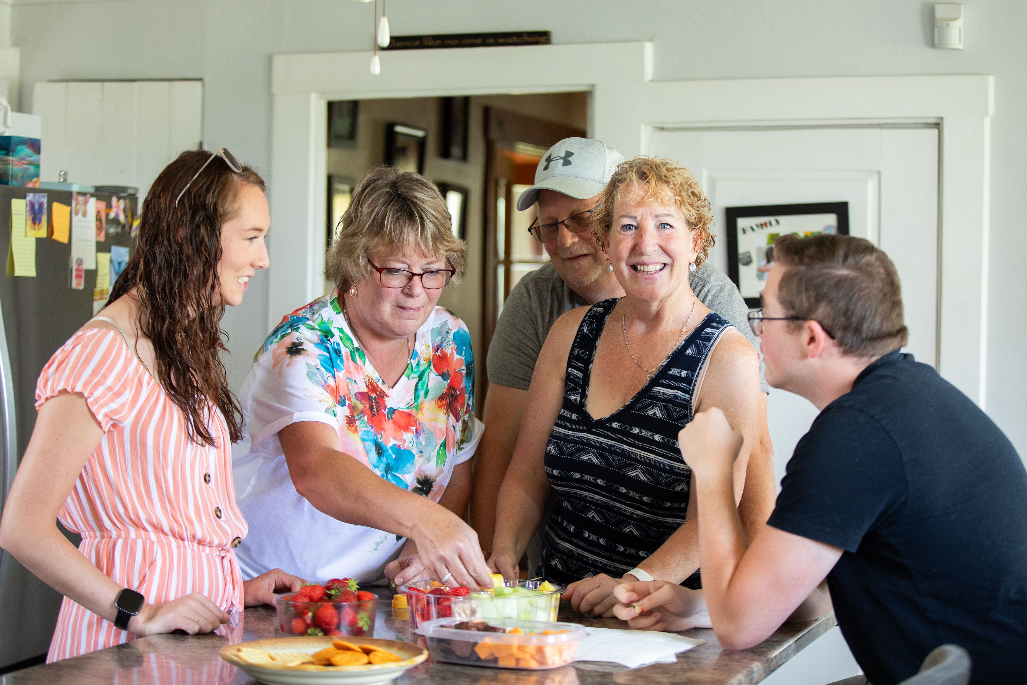 Cindy, surrounded by her family at a kitchen table.