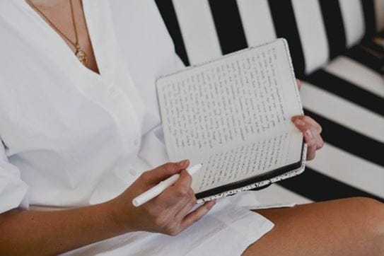 Person writing in a journal.