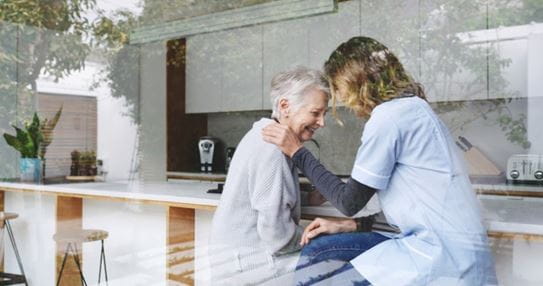 A caregiver comforting an elderly person with sympathy in nursing home.