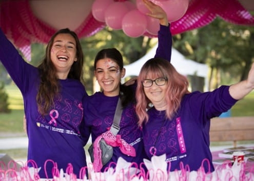 3 bénévoles, souriant, les bras dans les airs, avec le t-shirt de la Course à la vie CIBC de la Société canadienne du cancer