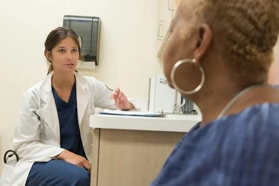A person talking to a doctor.
