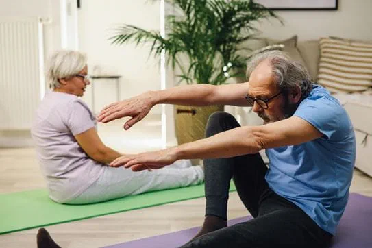 Two people doing yoga on the floor.