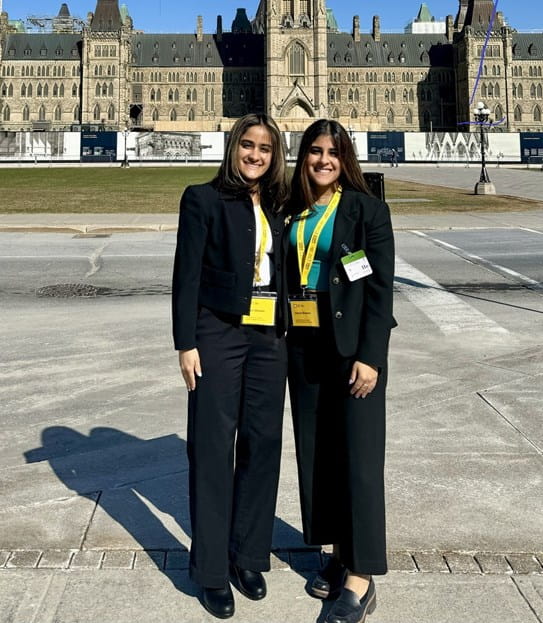 Alaina and Jillian Dhawan, standing on Parliament Hill.