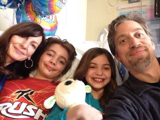 Jakob in the hospital with his loving family.