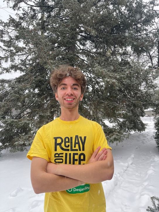 Jakob, outside, wearing a Relay For Life t-shirt.